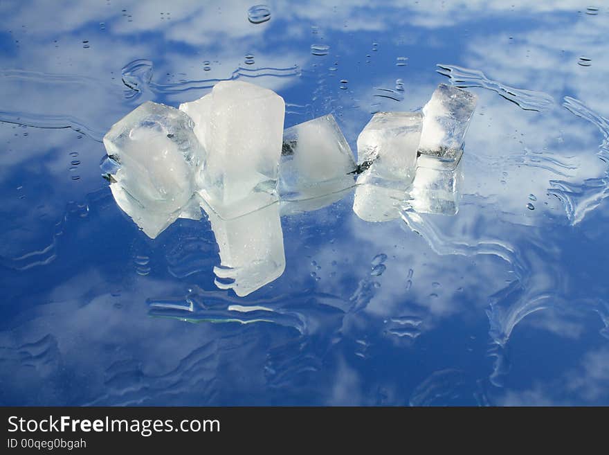 Flinders of ice and water on blue sky background. Flinders of ice and water on blue sky background