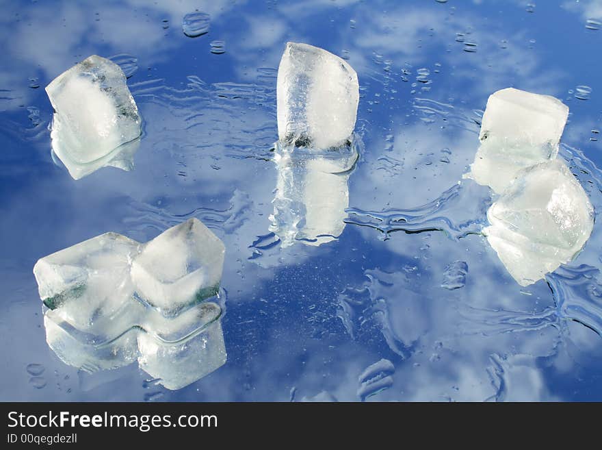 Flinders of ice and water on blue sky background. Flinders of ice and water on blue sky background