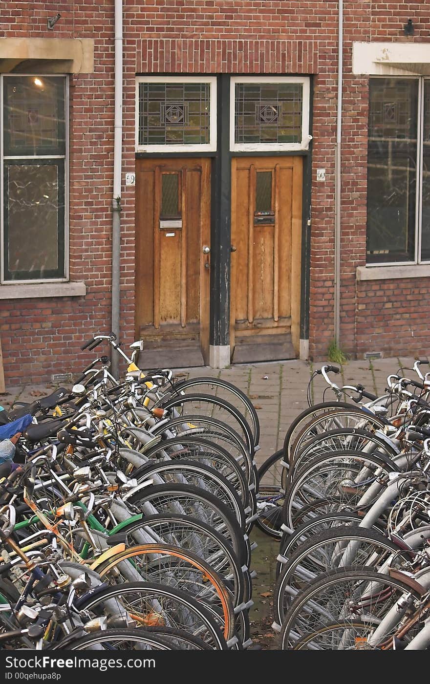 Bicycles parked in front of a residential building. Bicycles parked in front of a residential building