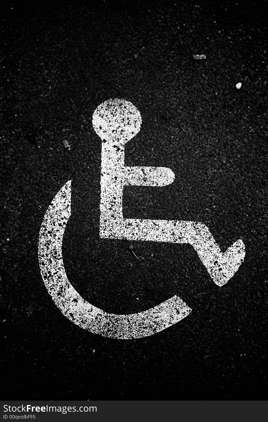 An handicapped sign or symbol on the floor of the street