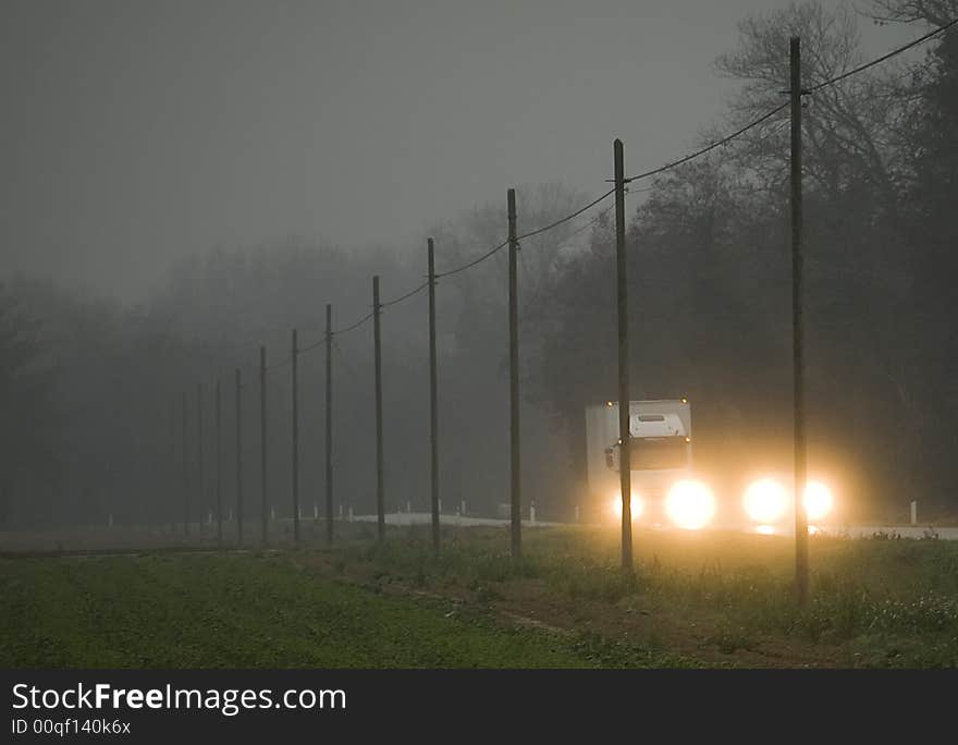 Two vehicles are driving in early, foggy morning. Two vehicles are driving in early, foggy morning