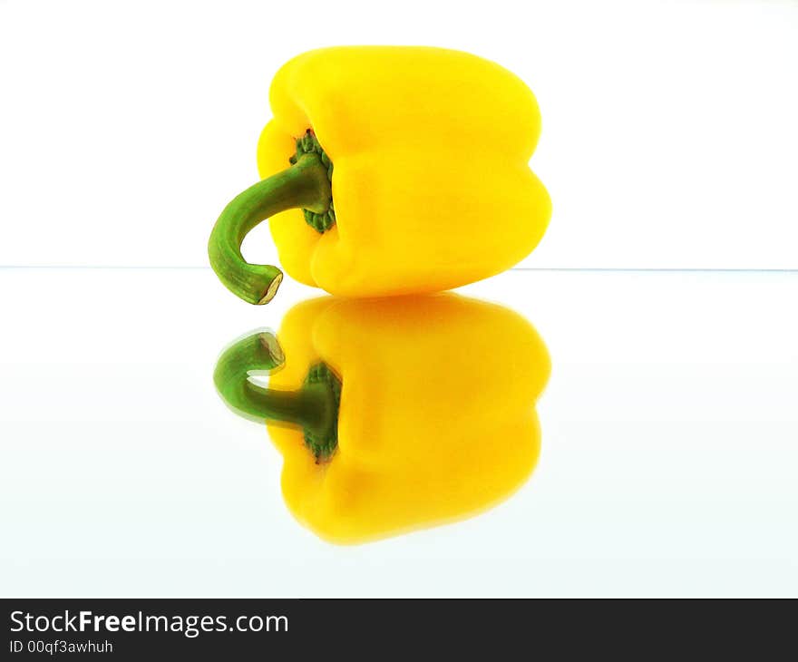 Yellow Pepper on mirror on white