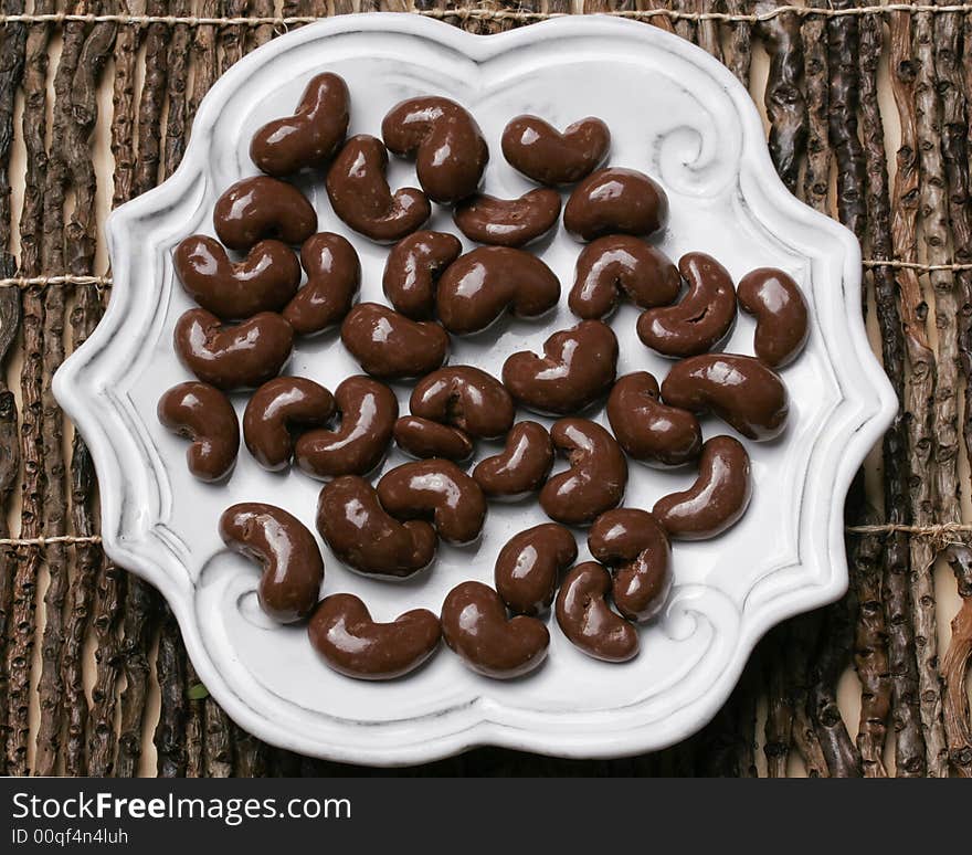 Yummy plate of chocolate covered cashew nuts for sharing or just one. Yummy plate of chocolate covered cashew nuts for sharing or just one.