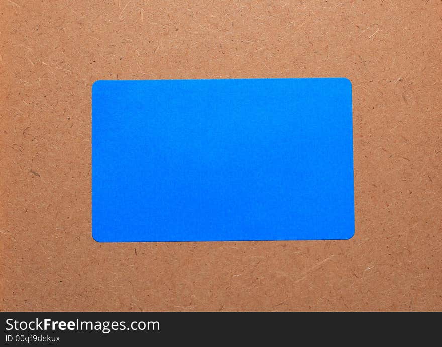 Blue paper on a wooden background.Note paper. Card