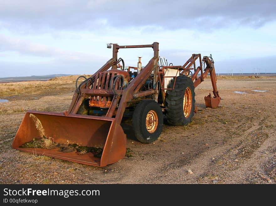 An old abandoned loading vehicle in a disused sand quarry. An old abandoned loading vehicle in a disused sand quarry.