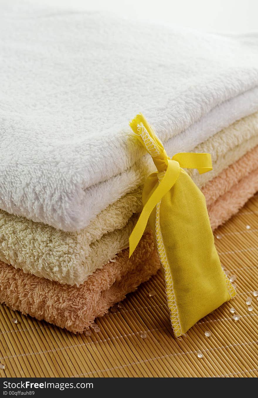 Towels in gentle colors with scent yellow bag and salt pearls. Towels in gentle colors with scent yellow bag and salt pearls