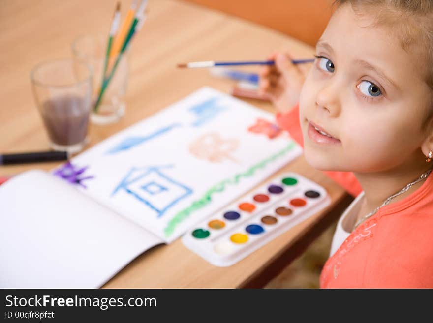 Pretty caucasian girl watercolor paint and look in camera. Close-up. Pretty caucasian girl watercolor paint and look in camera. Close-up