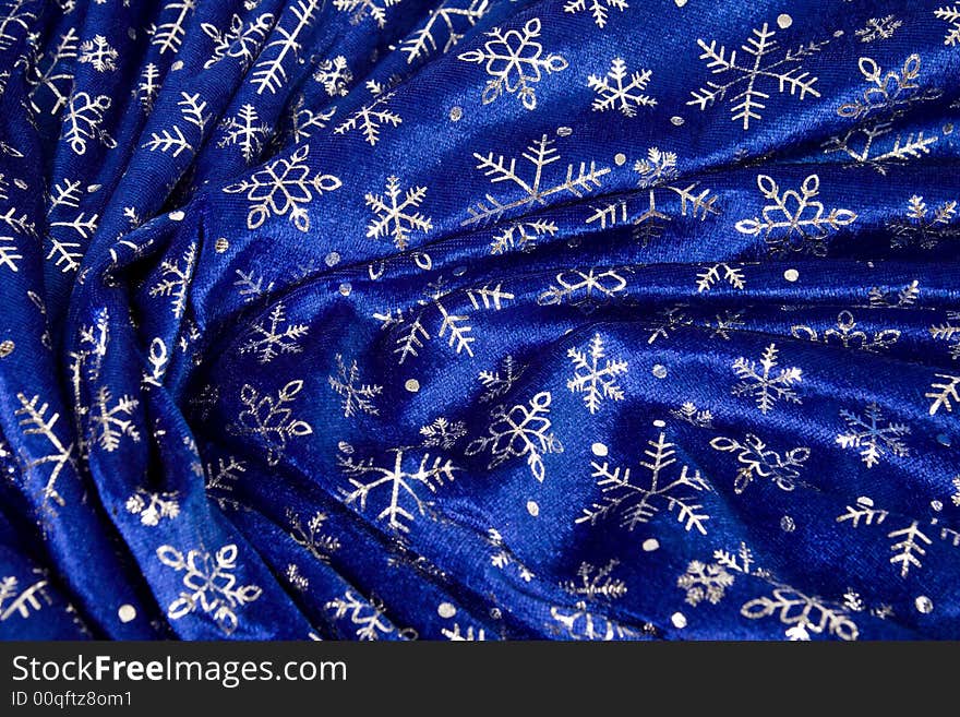 Crumple blue cloth with snowflakes