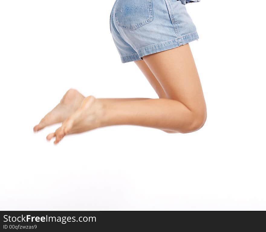 Female jumping on a white background - waist down shot