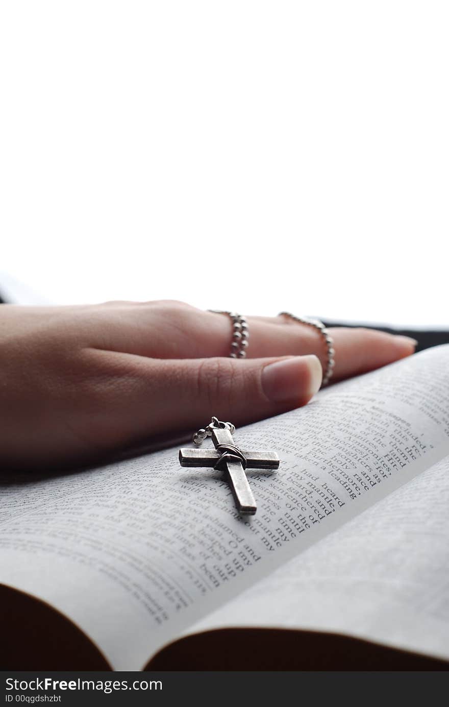 Holy bible open with a cross on a hand. Holy bible open with a cross on a hand