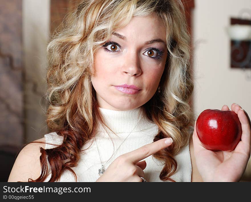 Beautiful woman is holding a fruit in her hands. Beautiful woman is holding a fruit in her hands