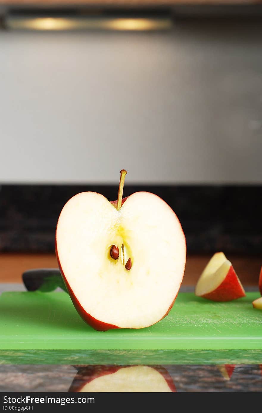 Apple on the counter symbolizes healthy living and nutritional value. Apple on the counter symbolizes healthy living and nutritional value