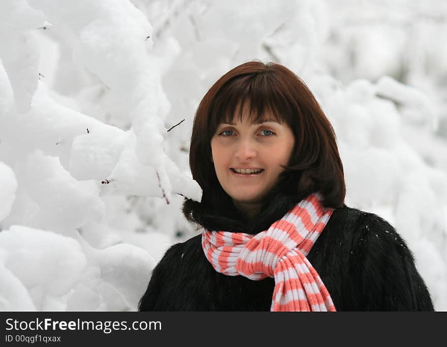 Portrait of the woman on a background of snow branches