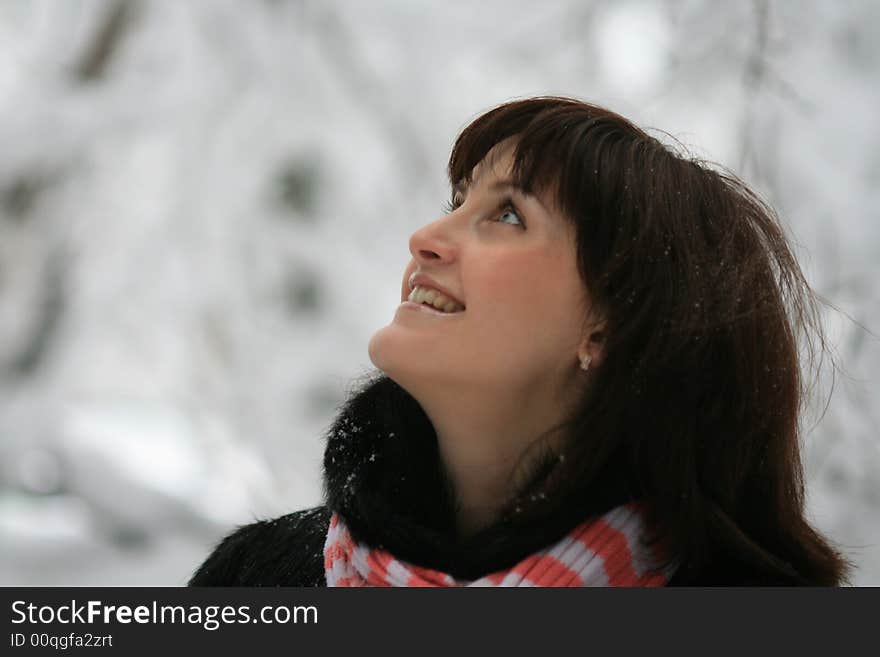 Young woman under a falling snow