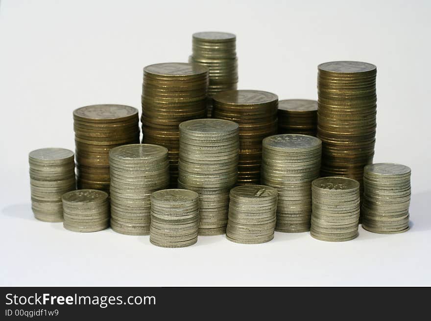 Close-up of multicolor coins stacks on the white background (isolated on white)