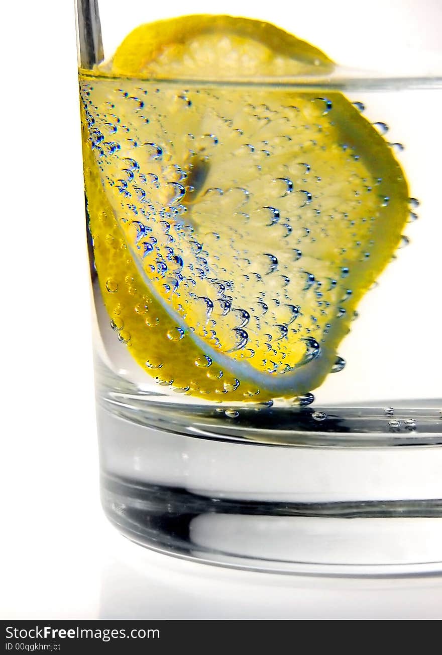 Lemon in water, drink detalis, close up