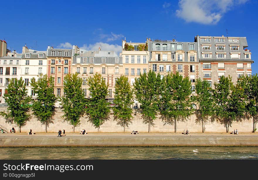 France, Paris: Monument of Paris along the Seine river; blue sky; yellow stones and green trees. France, Paris: Monument of Paris along the Seine river; blue sky; yellow stones and green trees