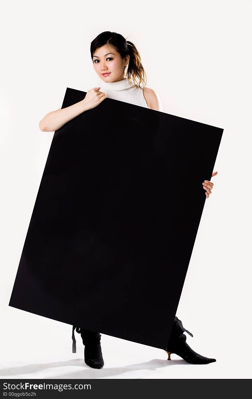 Young woman holding a big black sign. Young woman holding a big black sign