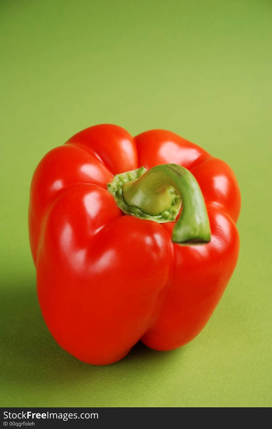 Red pepper on green background