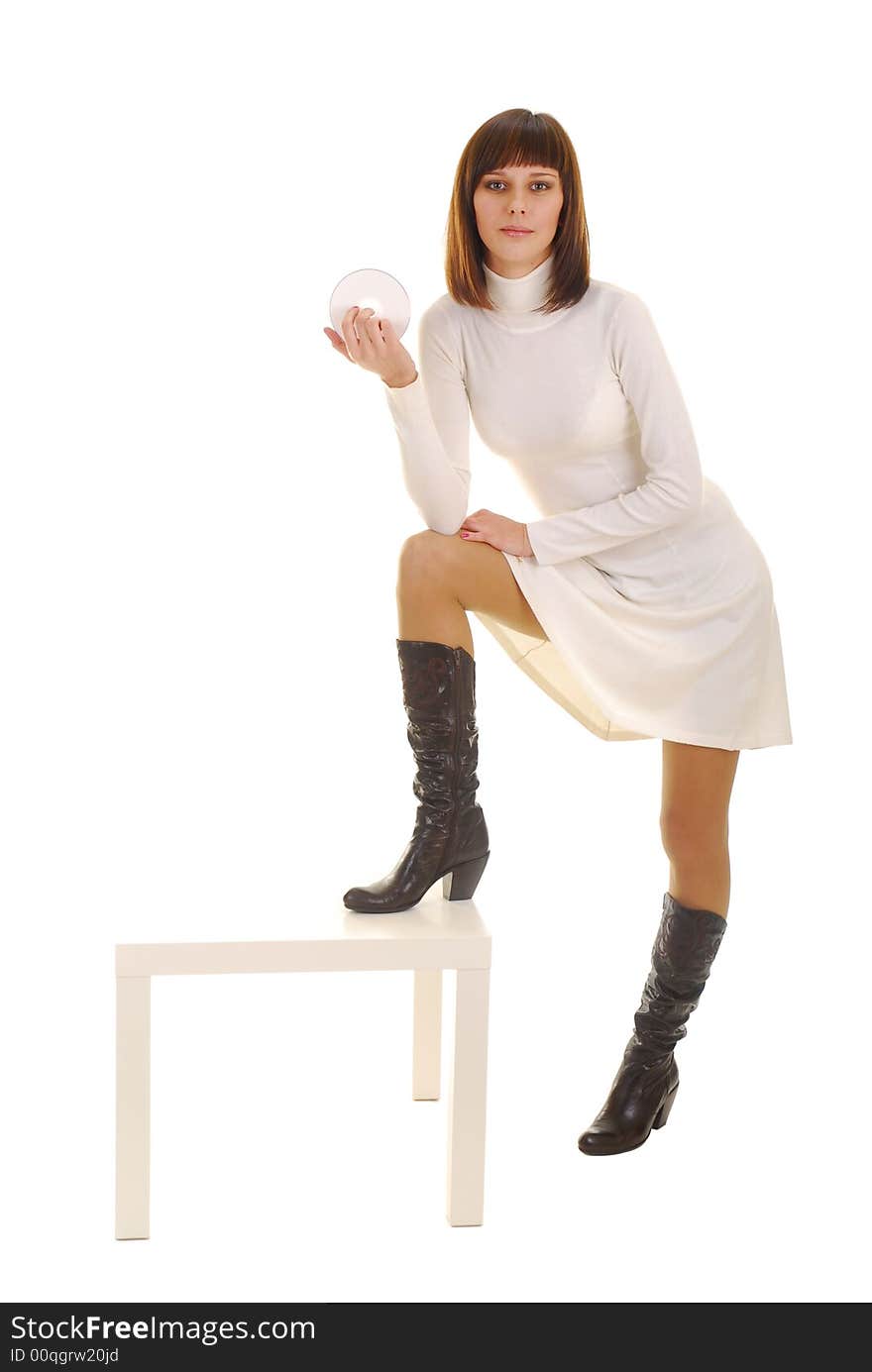 Young woman in white dress with white disk on white background