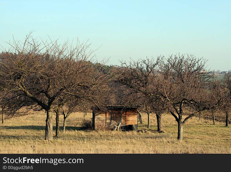 An old kennel in autumn orchard