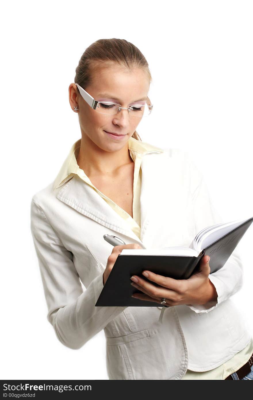 Business portrait of a young and successful woman writing at a folder. Business portrait of a young and successful woman writing at a folder