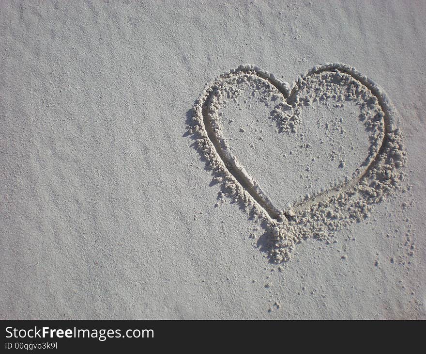 Valentines heart in the sand on the beach