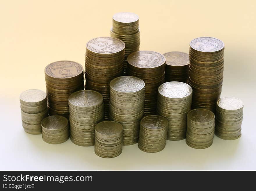 Close-up of multicolor coins stacks on the white background (isolated on white)