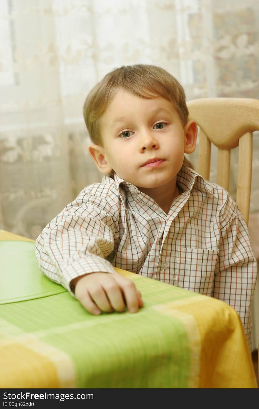 A 4 year old boy portrait at kitchen