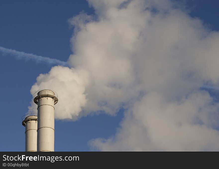 Big smoke pipes and blue sky.