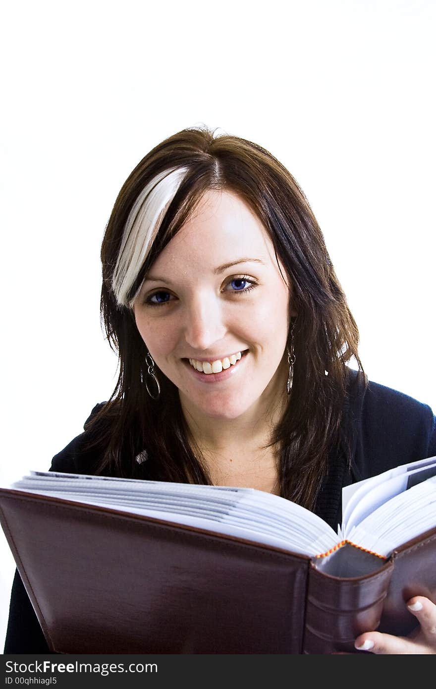 Photo of a young woman reading a book with a high key background