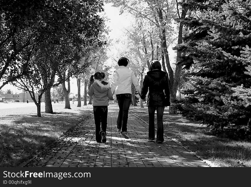 Sisters walking along path in black and white