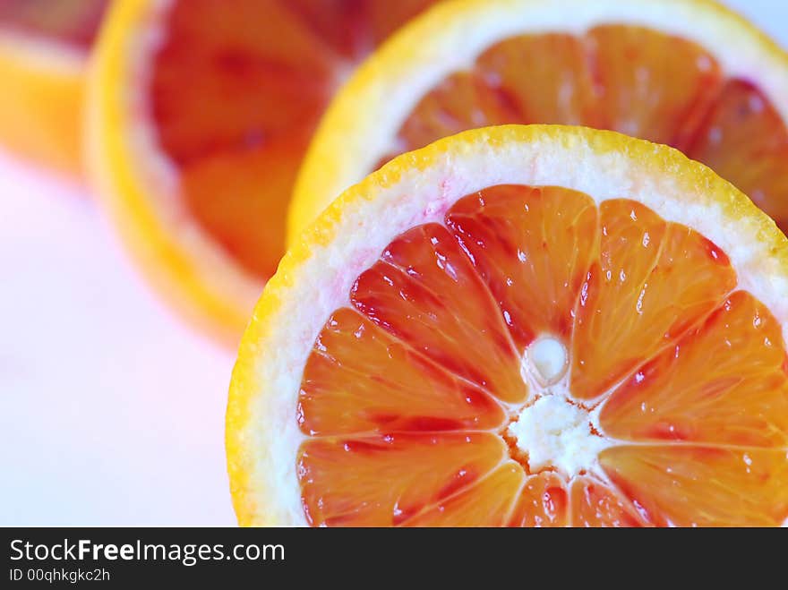 Slices of red orange on white background