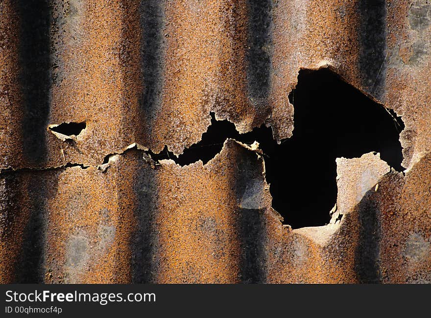 Close-up photo of a rusted and crushed sheet.