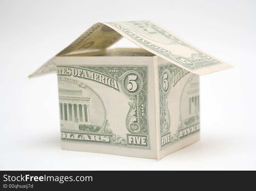 House made from dollar bills on light background. House made from dollar bills on light background