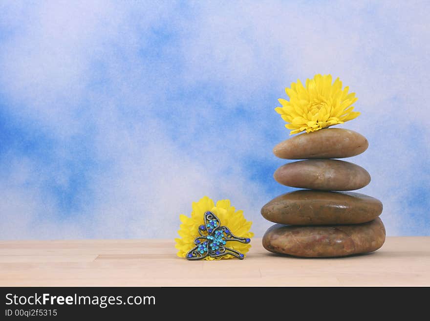 Balanced Massage Stones on Blue Textured Background