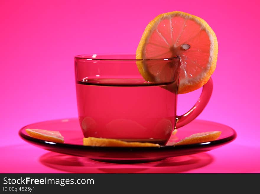 It is a cup with a lemons on a pink background. It is a cup with a lemons on a pink background.