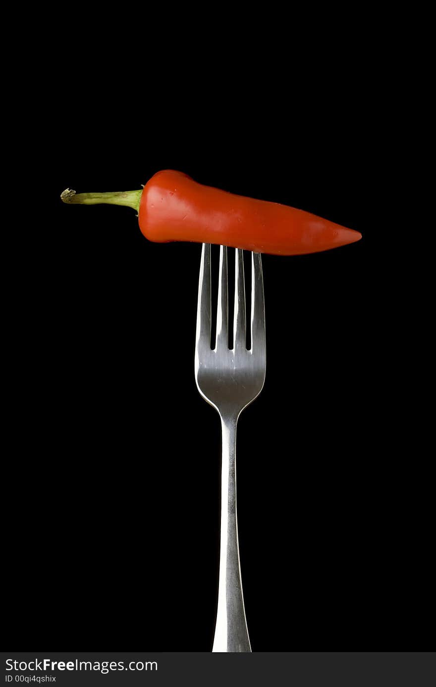 Red pepper on a silver fork