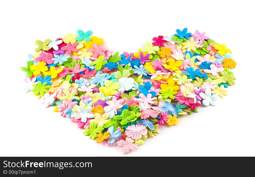 A pile of spring hued flowers shaped into an attactive heart shape on a white background. A pile of spring hued flowers shaped into an attactive heart shape on a white background.