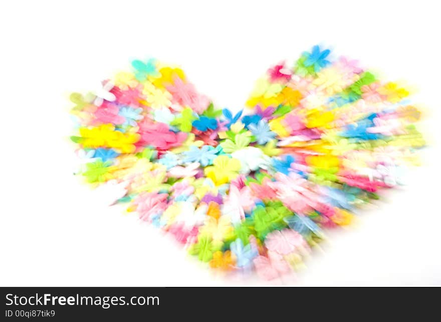 A softly focus heart made out of spring colored flowers. Zoomed to add movement. A softly focus heart made out of spring colored flowers. Zoomed to add movement.