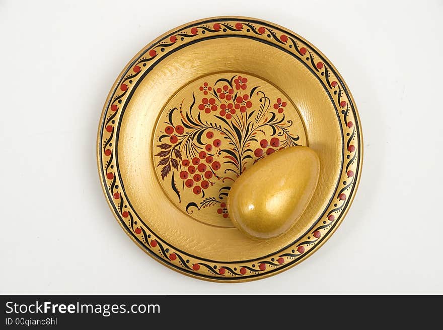 Colour wooden dish with figure and gold egg. Colour wooden dish with figure and gold egg.