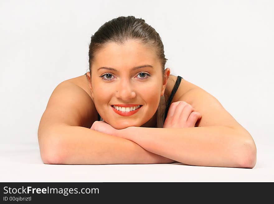 Young woman is lying over white background