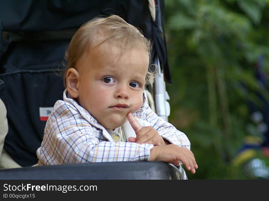 Child thinking while sitting in carriage. Child thinking while sitting in carriage