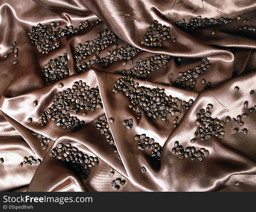 Coffee beans on the brown background