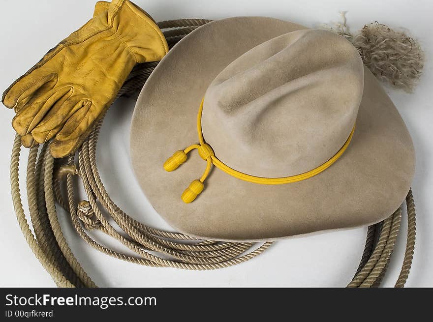 Cowboy hat on top of rope with gloves. Cowboy hat on top of rope with gloves