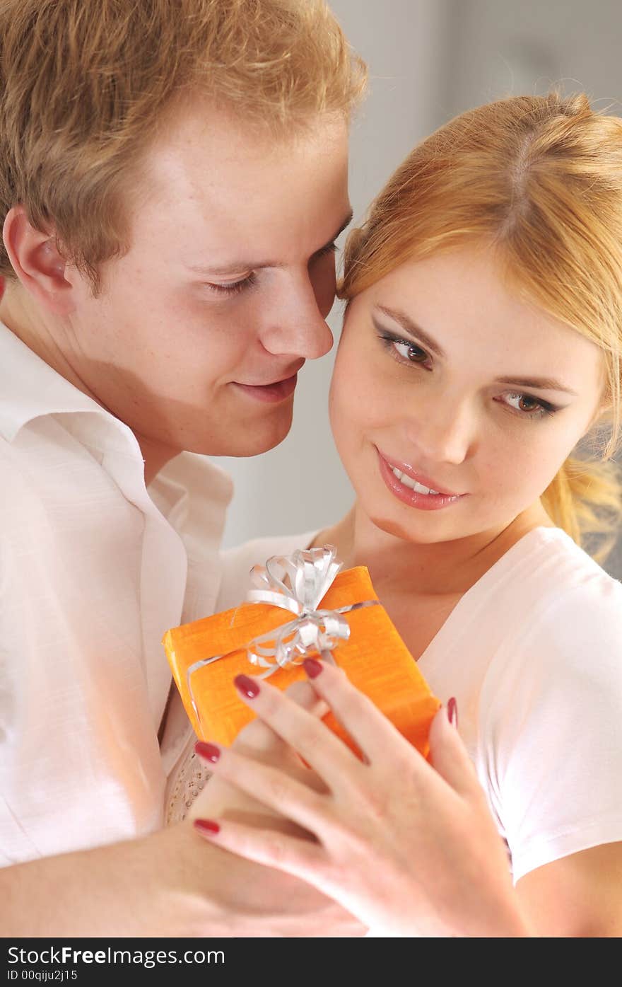 Young happy attractive couple with gift