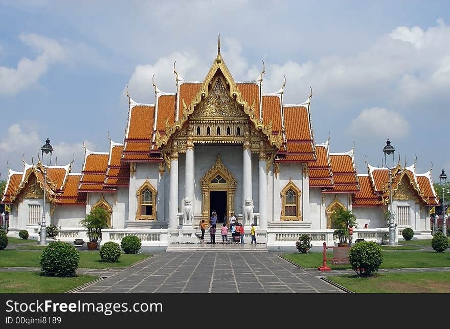 Budhist temple in Bangkok. People faces blurred.