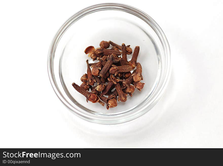 Cloves in saucer isolated on white