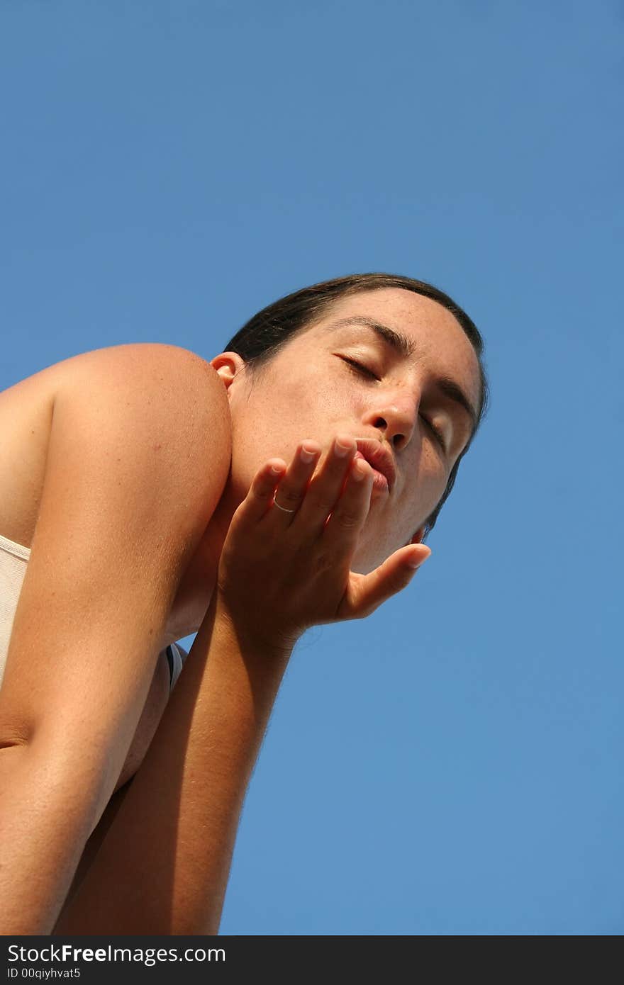 Portrait of a loving girl blowing away a kiss in a hand