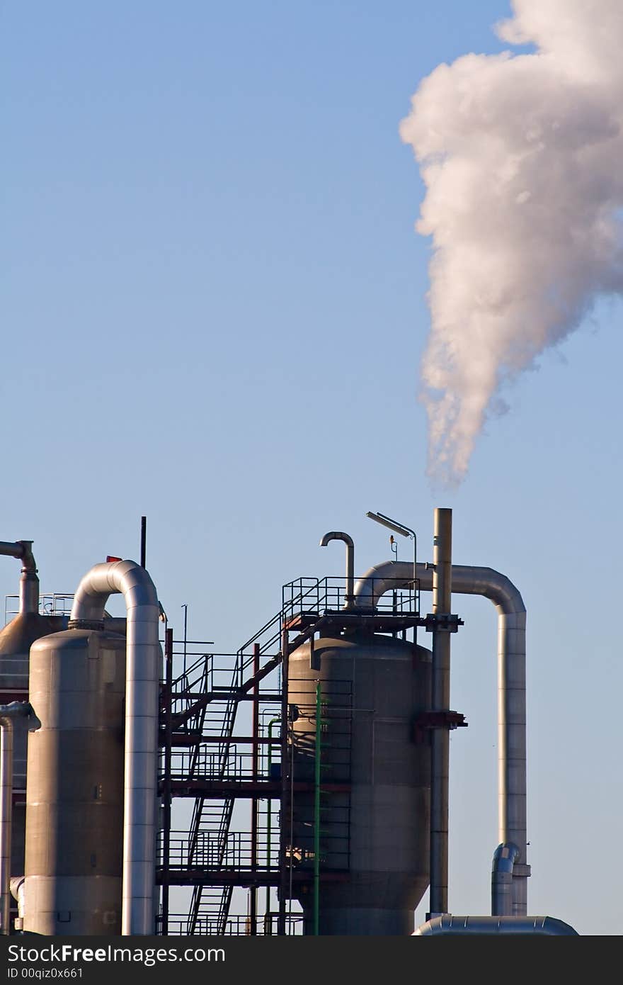 Industrial plant exhausting smokes into the atmosphere.